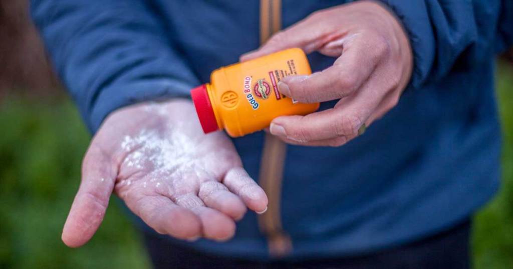 man shaking powder on his hand