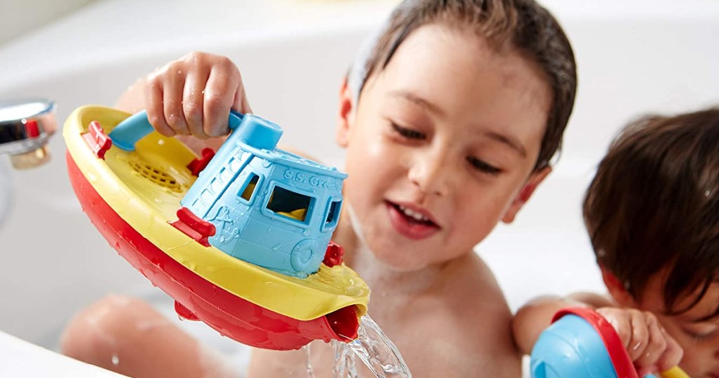 children in bubble bath playing with boats