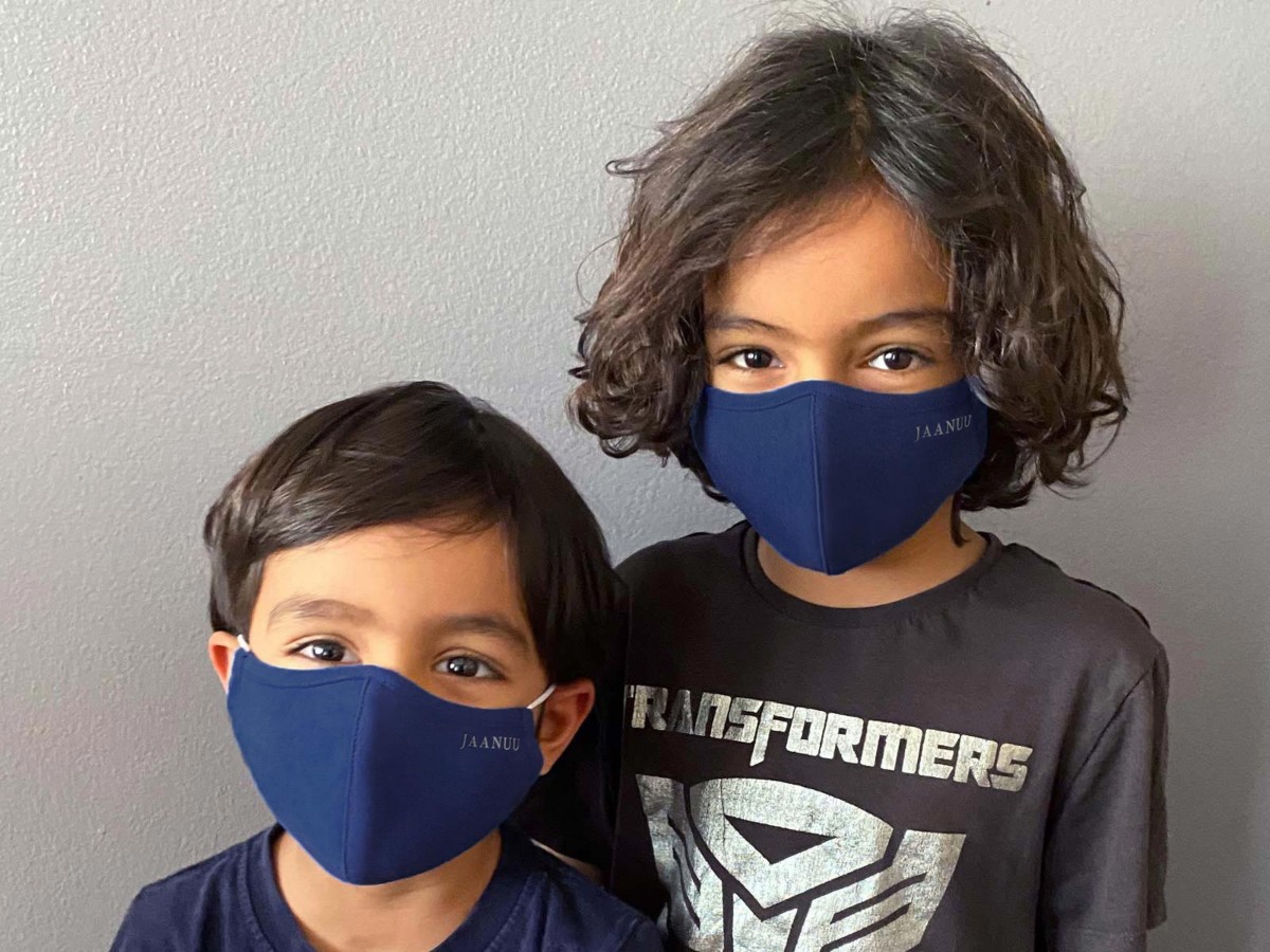 2 boys wearing blue face masks