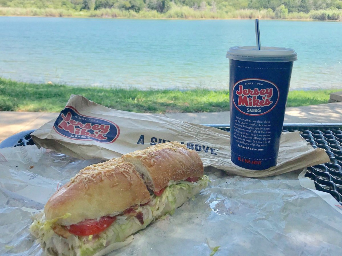 sub and blue cup near a lake