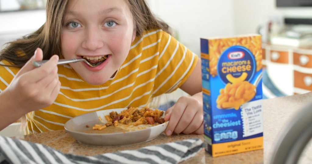 kid eating a plate of taco macaroni