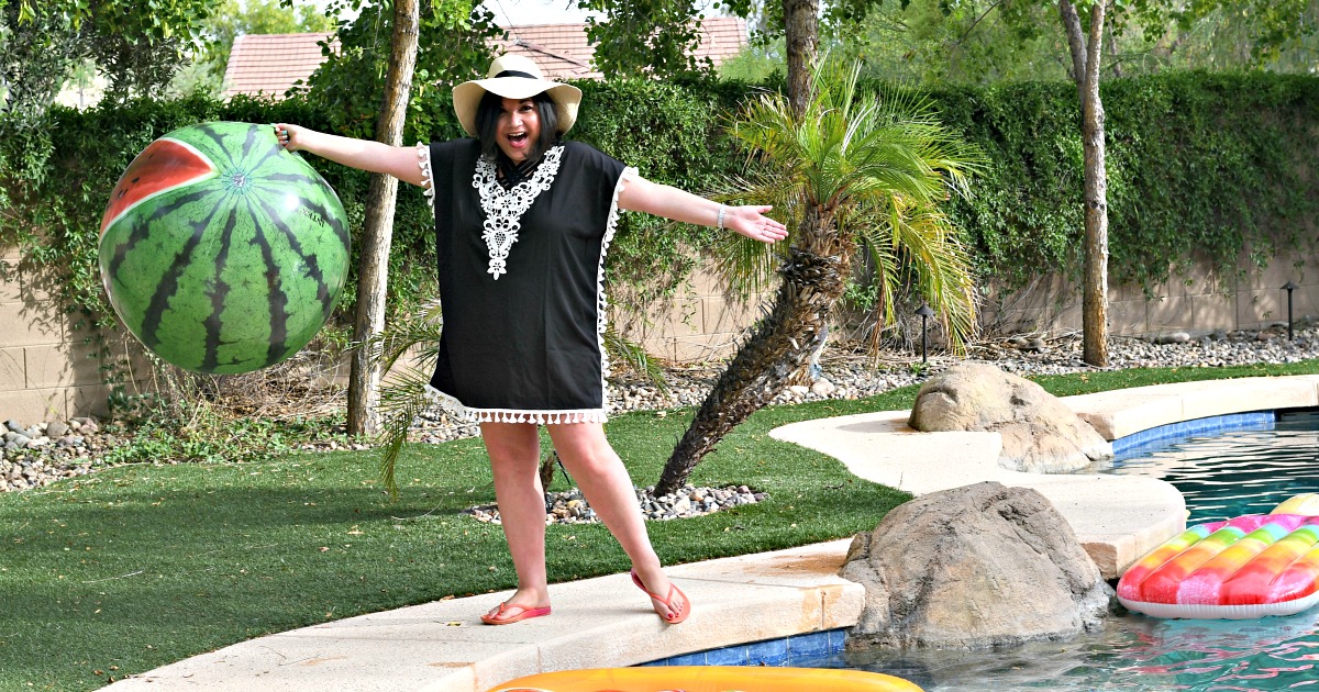 woman wearing swimsuit coverup by pool 