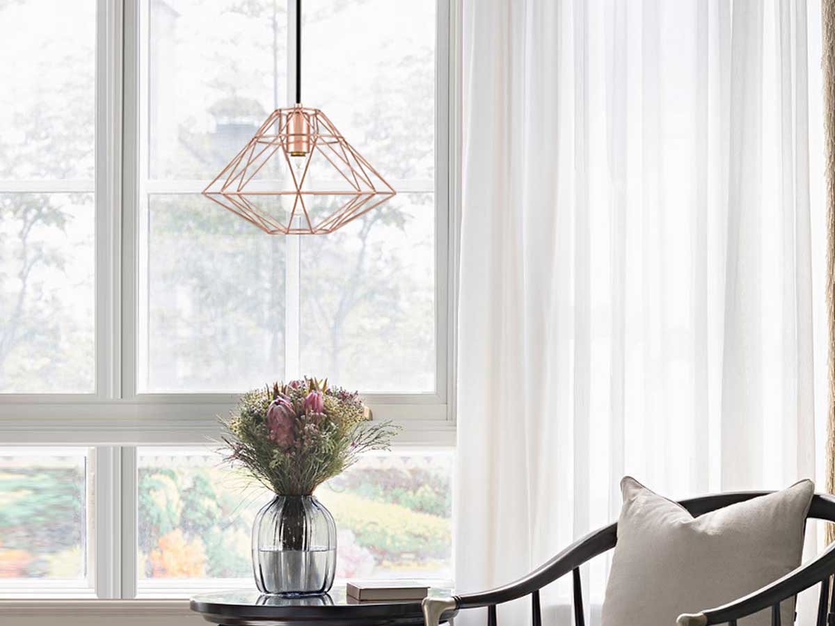 pendant light over a table with flowers