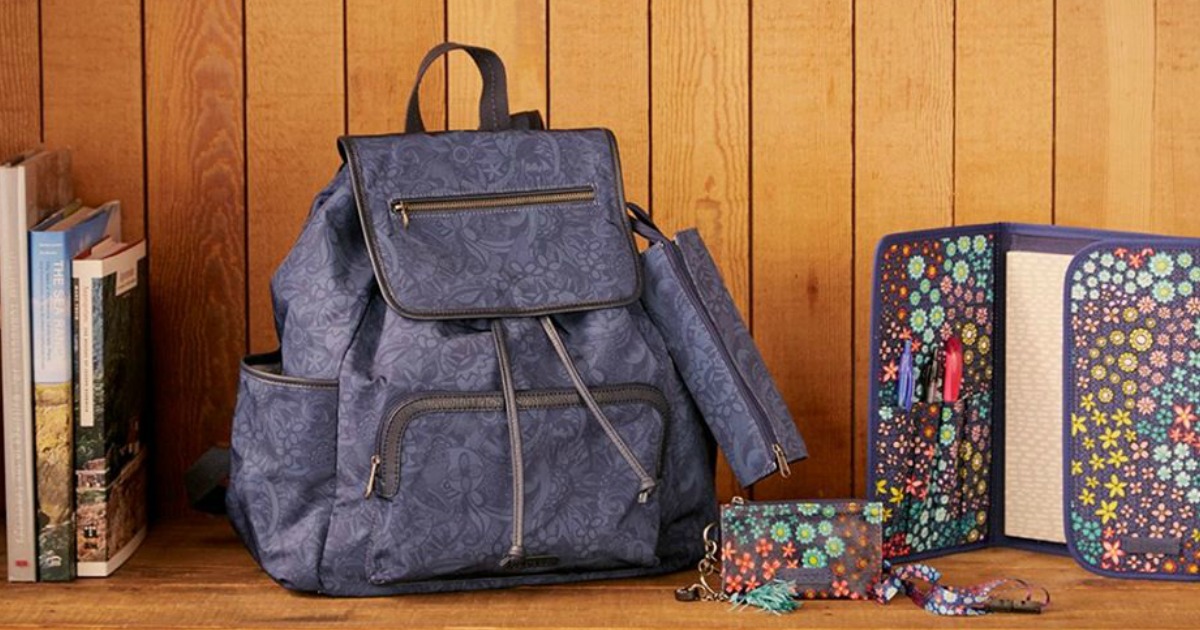 backpack sitting against wall with school supplies