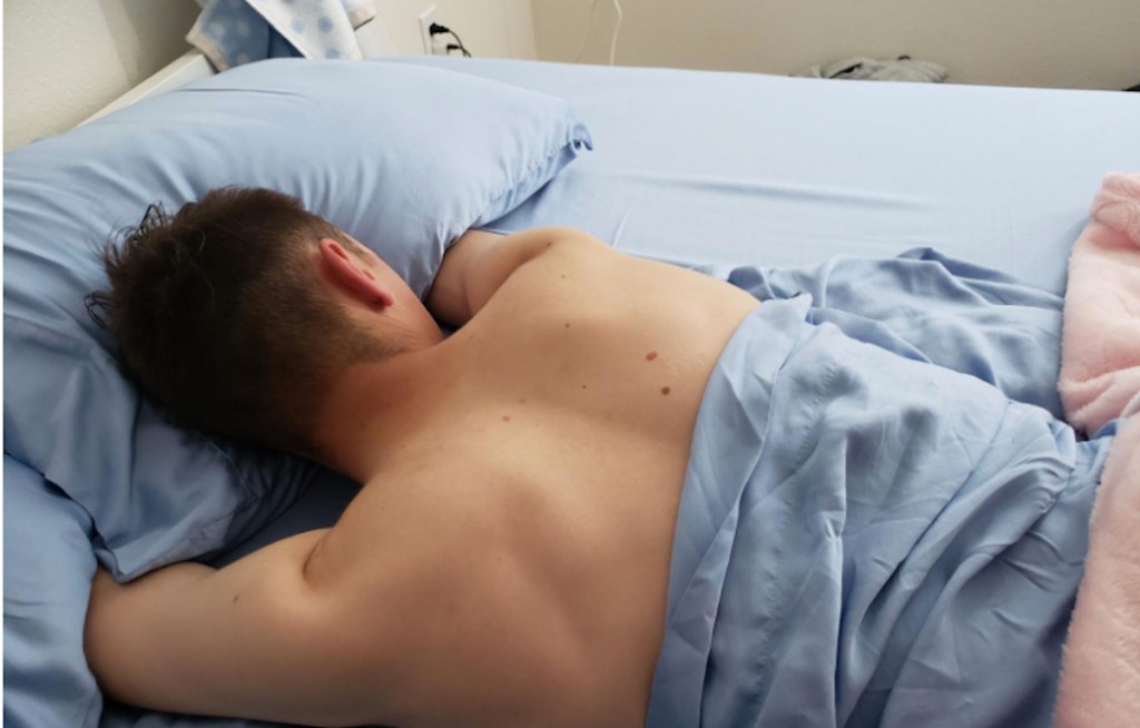 man laying on the best cooling bed sheets 