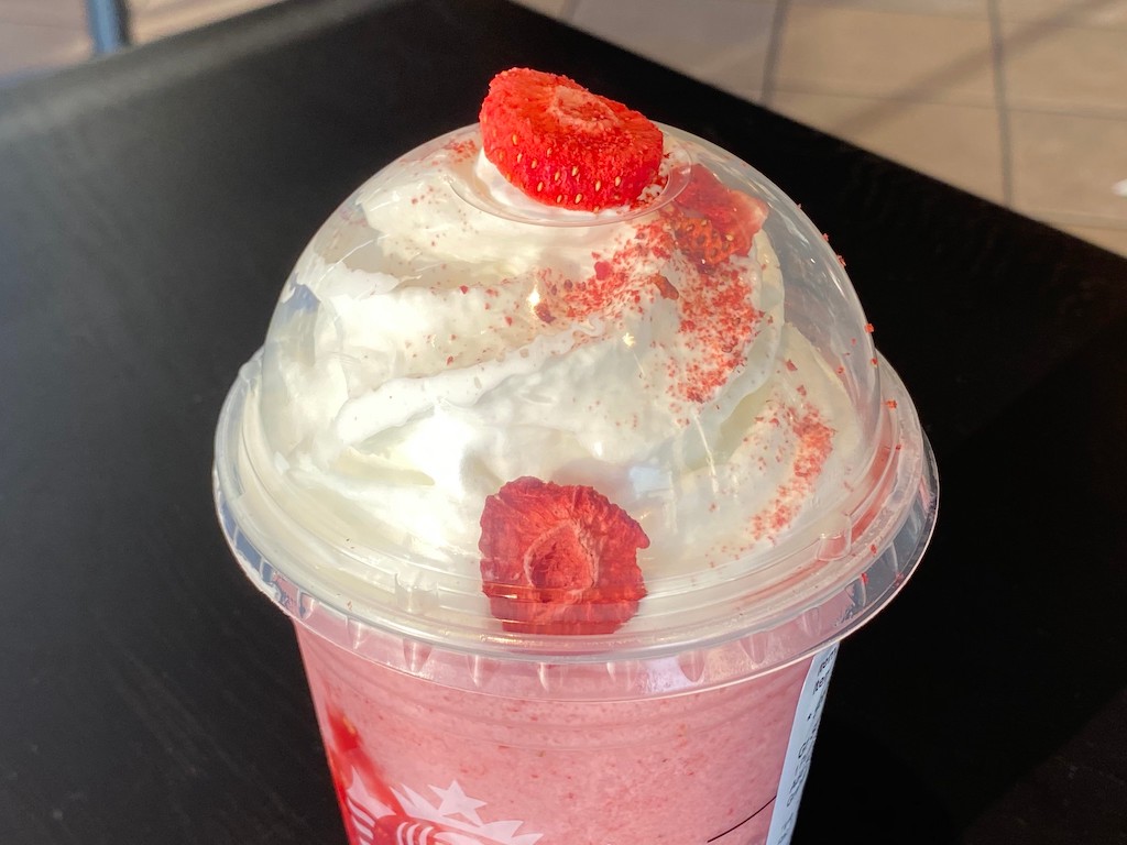 close up of Starbucks strawberry cheesecake frap with whipped cream