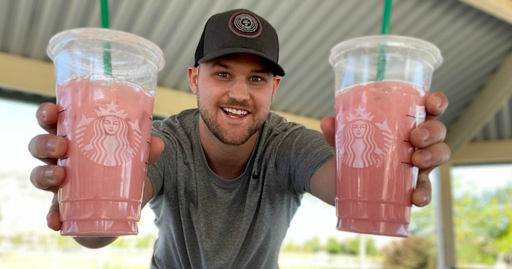 man holding two Starbucks iced drinks 