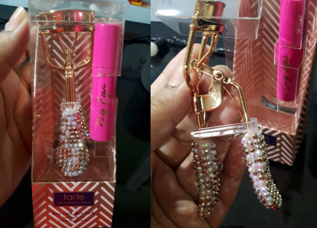 hand holding a box with diamond studded eyelash curler