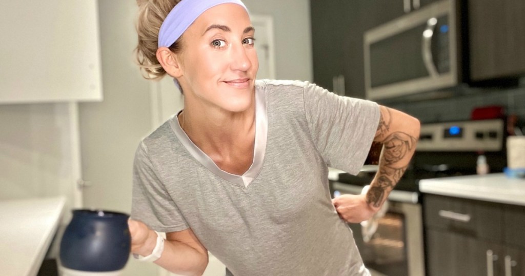 woman with headband wearing pajamas and drinking coffee