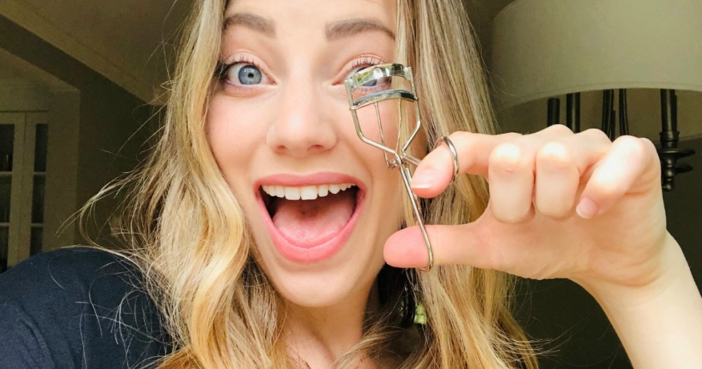 woman holding eyelash curler 