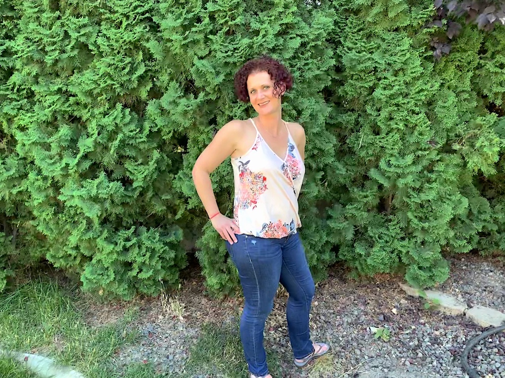 woman outside wearing jeans and tank top