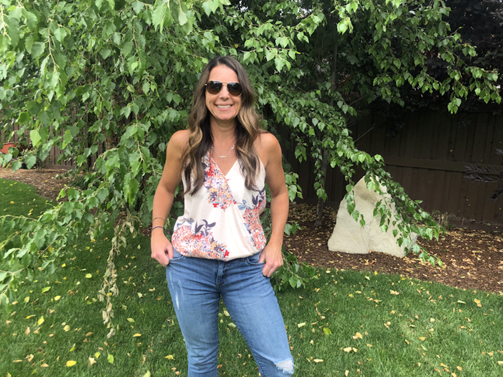 woman wearing jeans and tank top outside by tree 