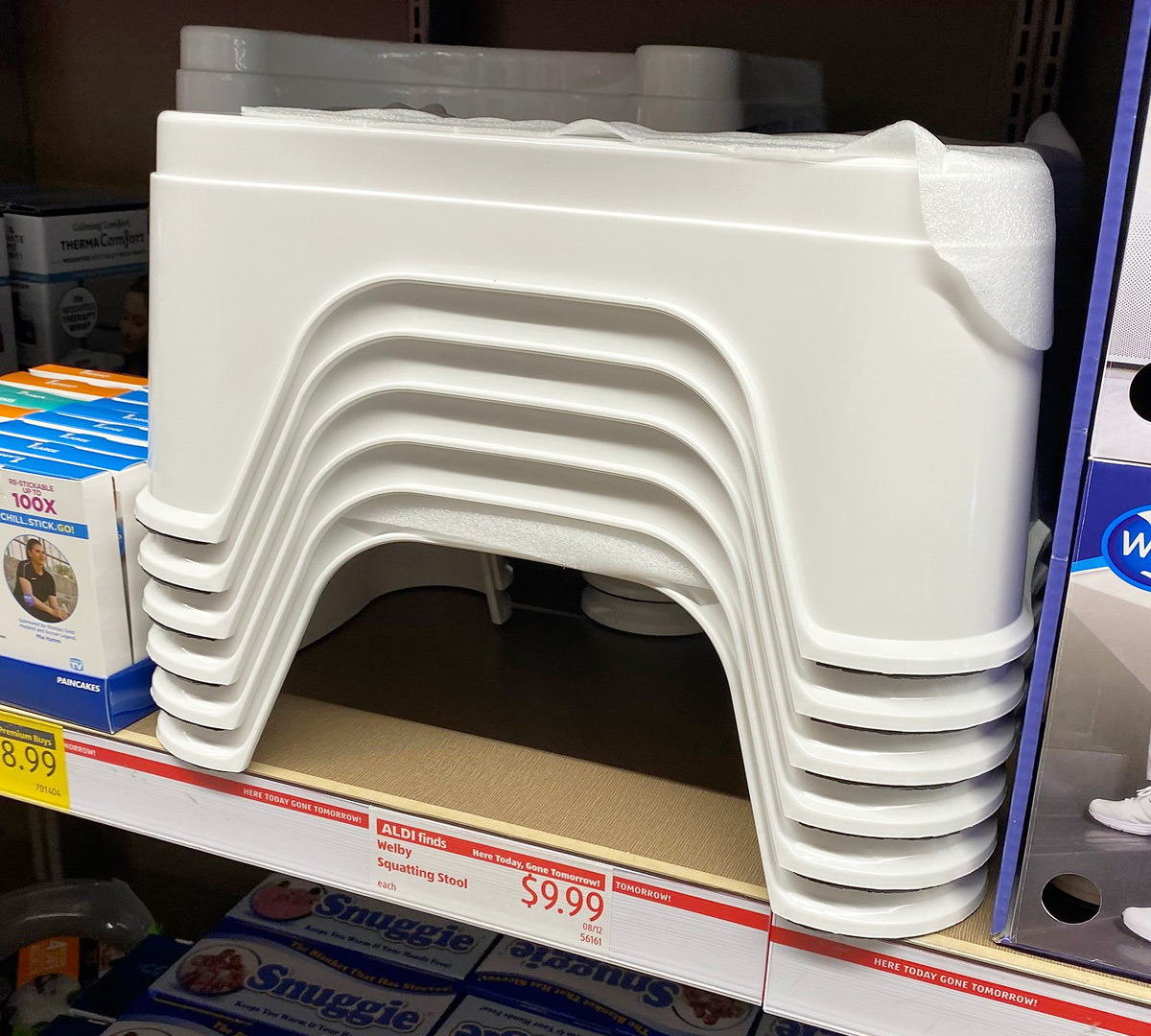 stack of white bathroom squatting stools on an ALDI store shelf