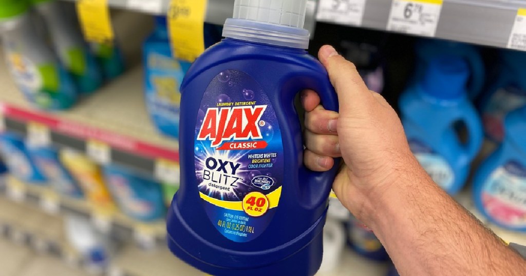 hand holding bottle of laundry detergent in store