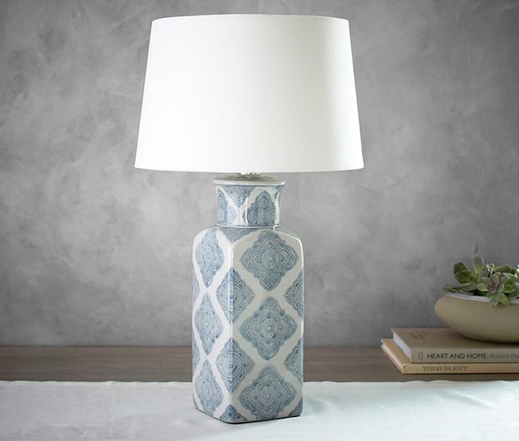 lamp with blue scallop print on case and white lamp shade