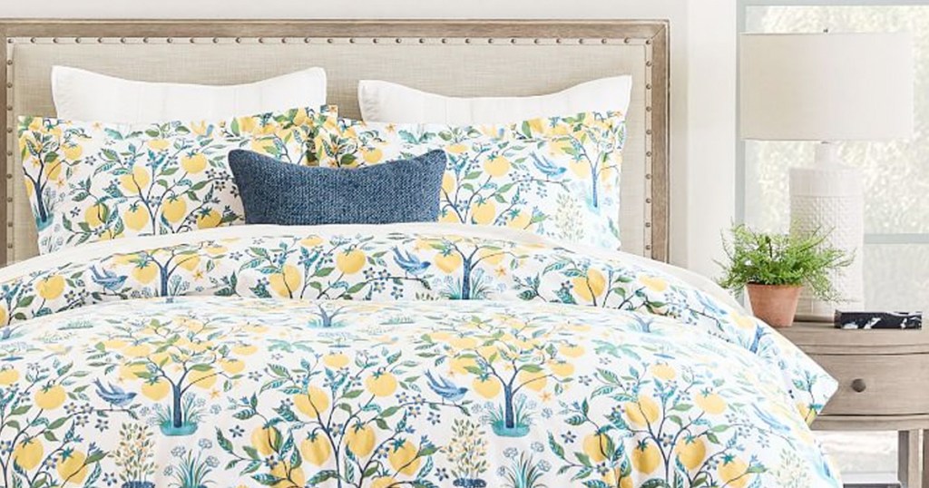 blue and yellow lemon print duvet cover on bed with matching pillow shams