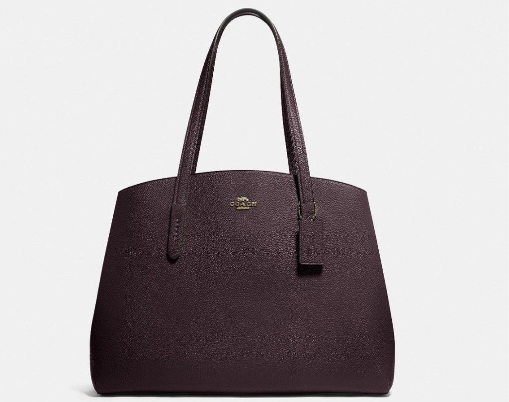 dark purple handbag with Coach monogram on front