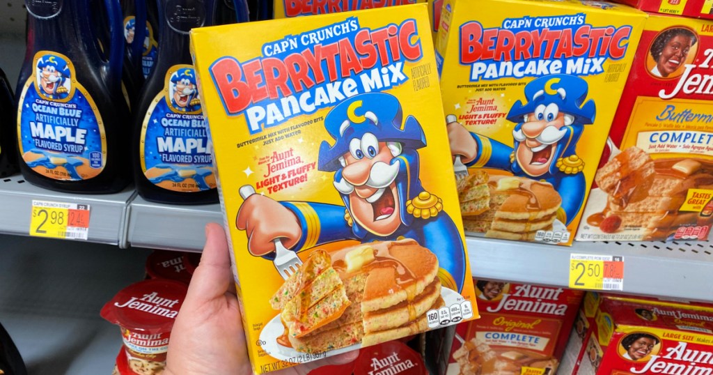 Cap'N Crunch Berrytastic Pancake Mix in person's hand at Walmart