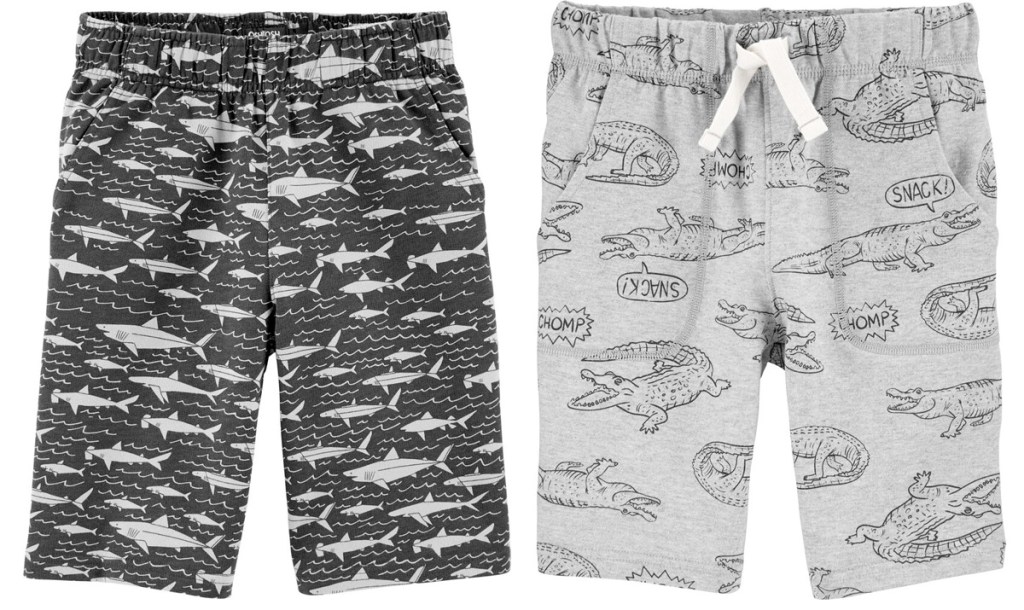 two pairs of Carter's boys shorts in grey with sharks and crocodile prints