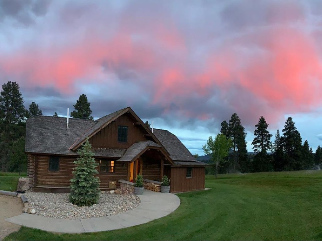 cabin with trees and sunset