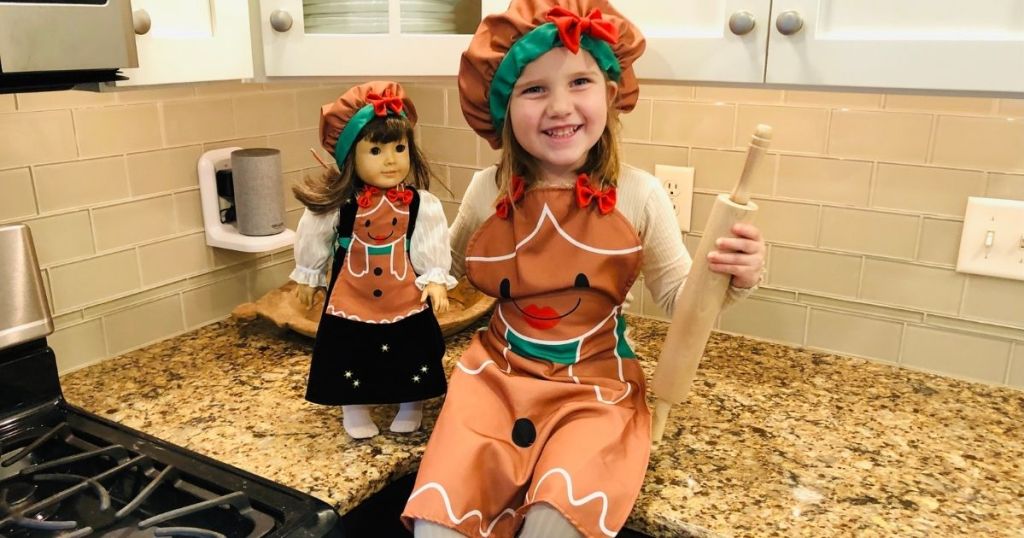 girl and doll in matching apron set