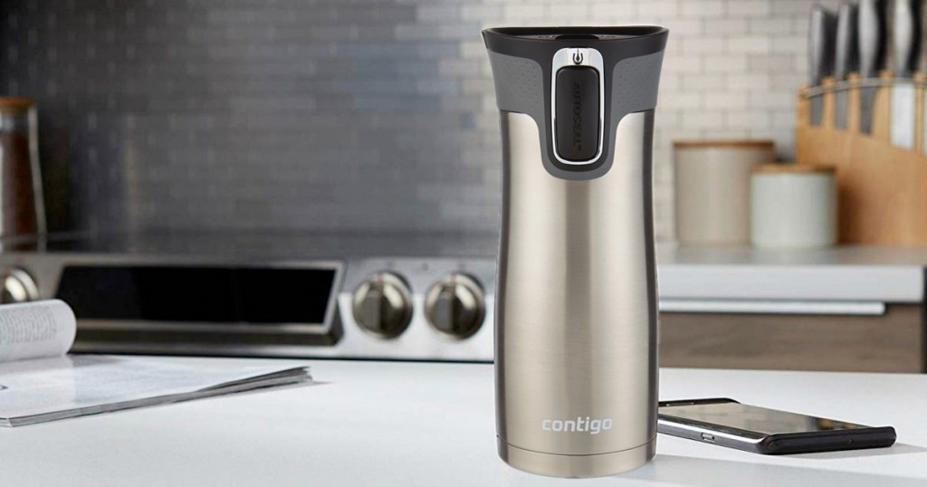 stainless steel travel mug with black lid sitting on a kitchen counter