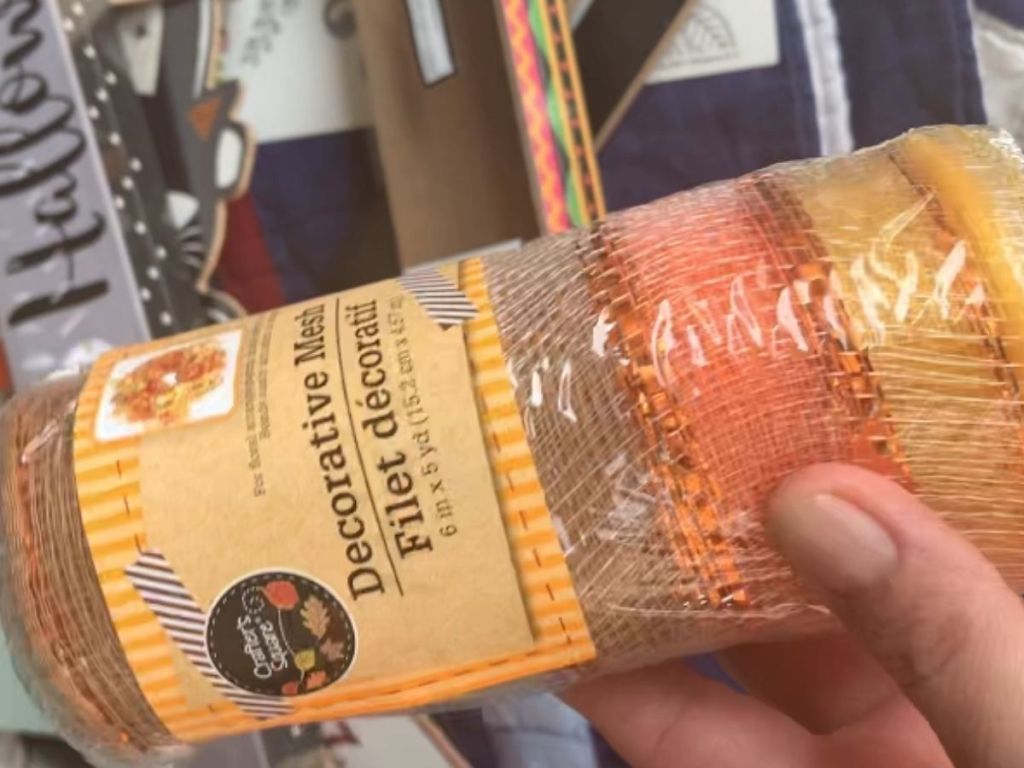 hand holding roll of decorative mesh
