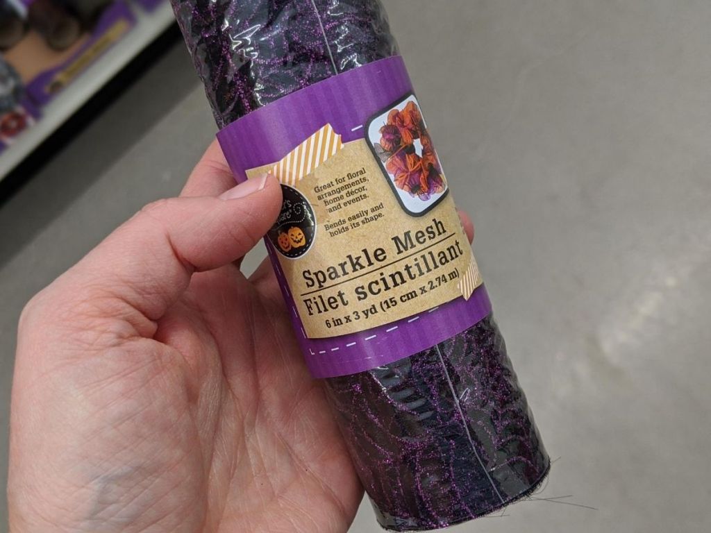 hand holding roll of decorative mesh