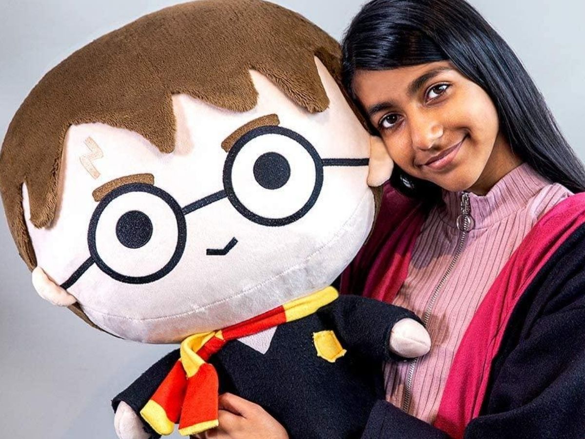girl holding a giant head harry potter toy