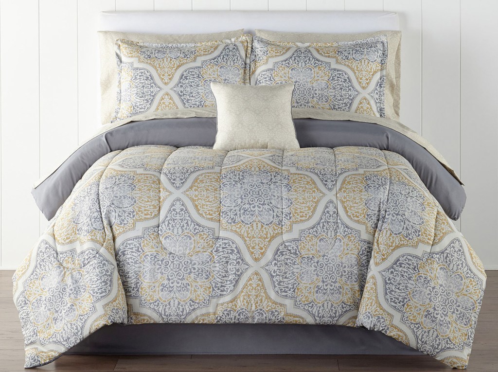 grey and yellow medallion print comforter set on bed with matching pillow cases and shams