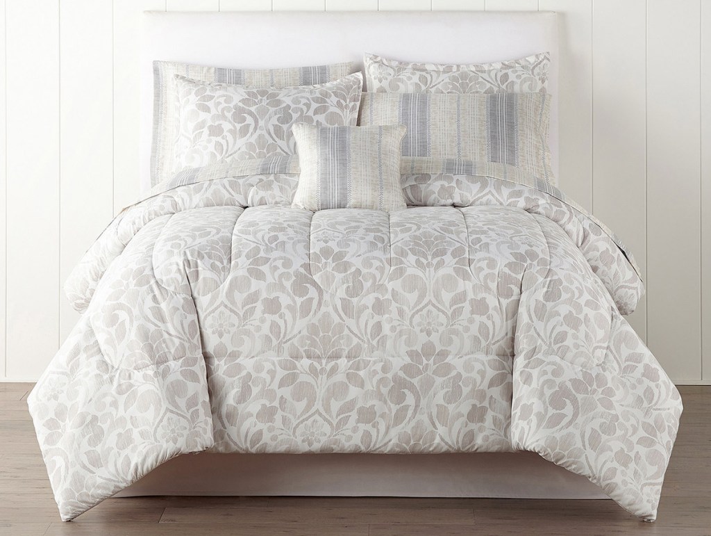 grey and white leaf printed comforter set on bed with matching pillowcases and shams