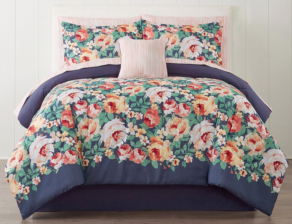 blue with bright floral pattern comforter set on bed with matching pillow cases and shams