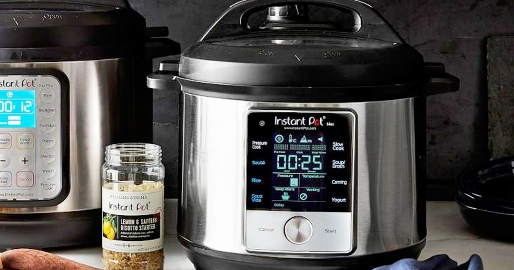 stainless steel and black instant pot max pressure cooker with bottle of instant pot brand seasoning next to it