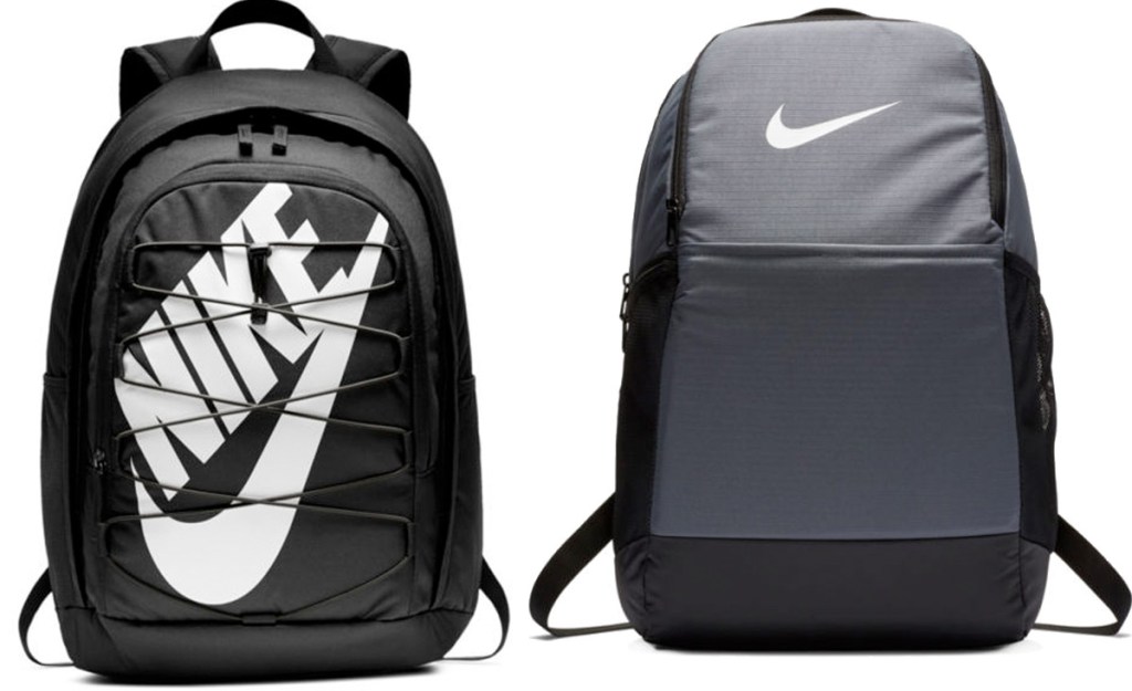 two black and grey nike backpacks with nike logo in white on front