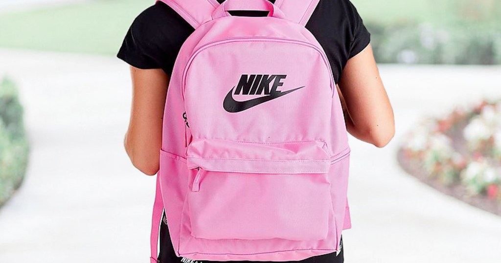 girl wearing black shirt and pink nike backpack with black nike logo