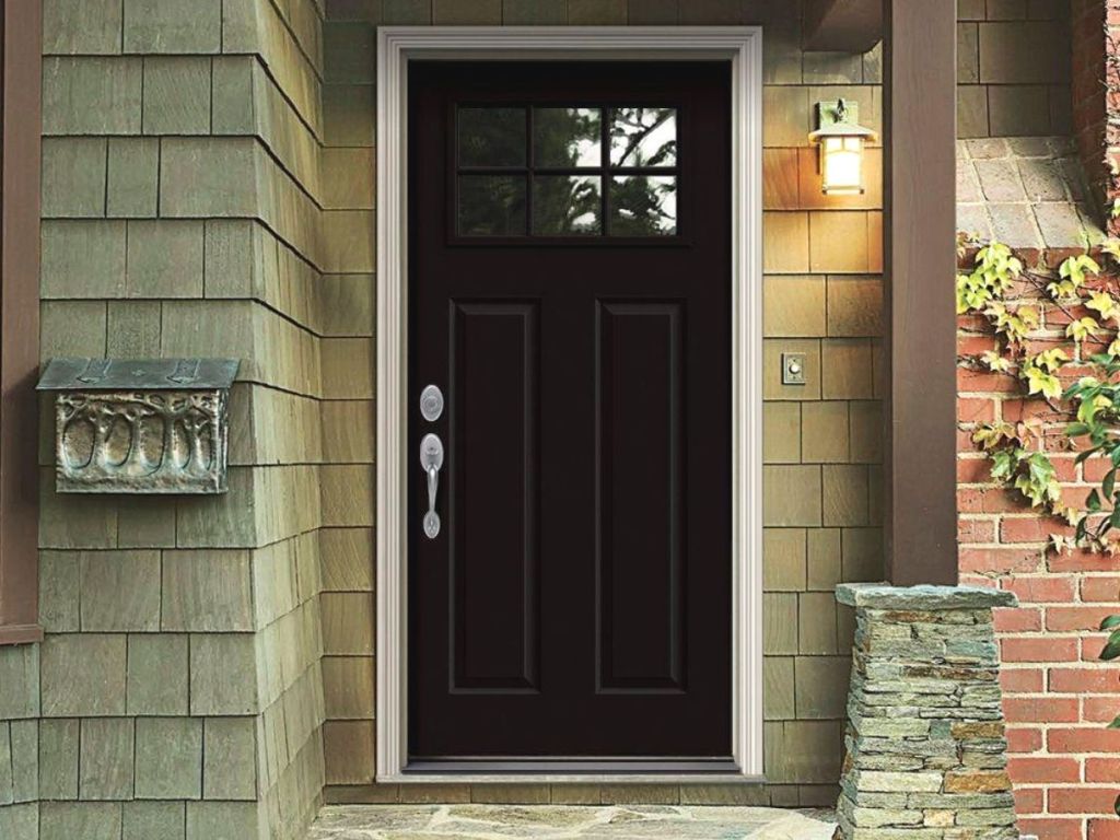 A front porch with a black door