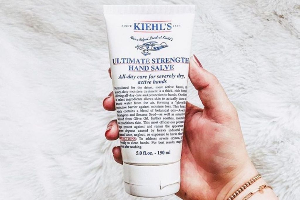 A hand holding hand cream