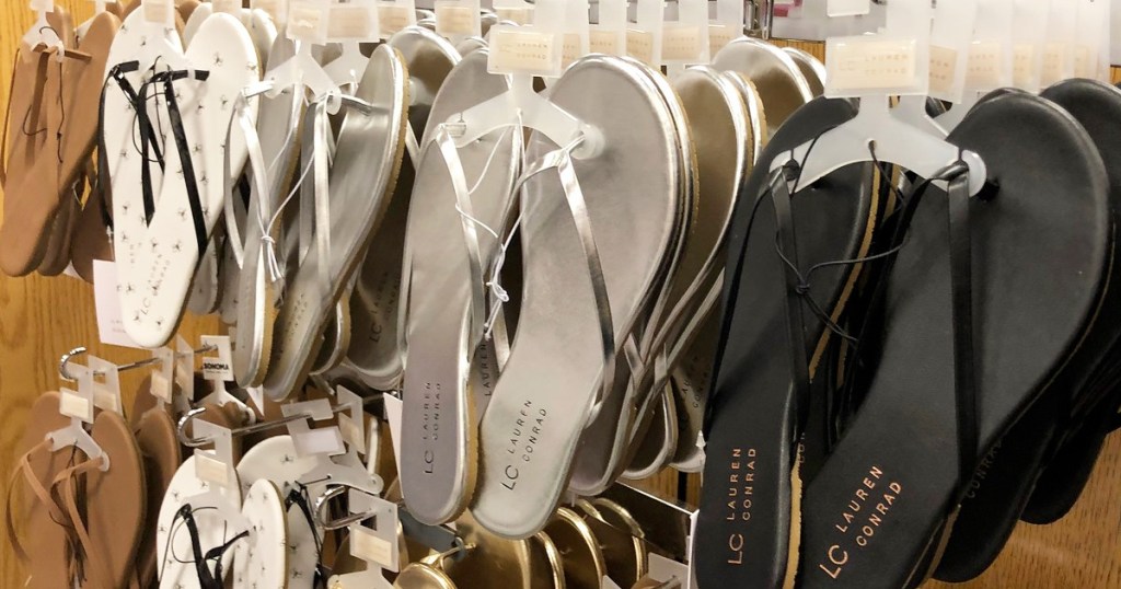 womens flip flops of various colors hanging on store display