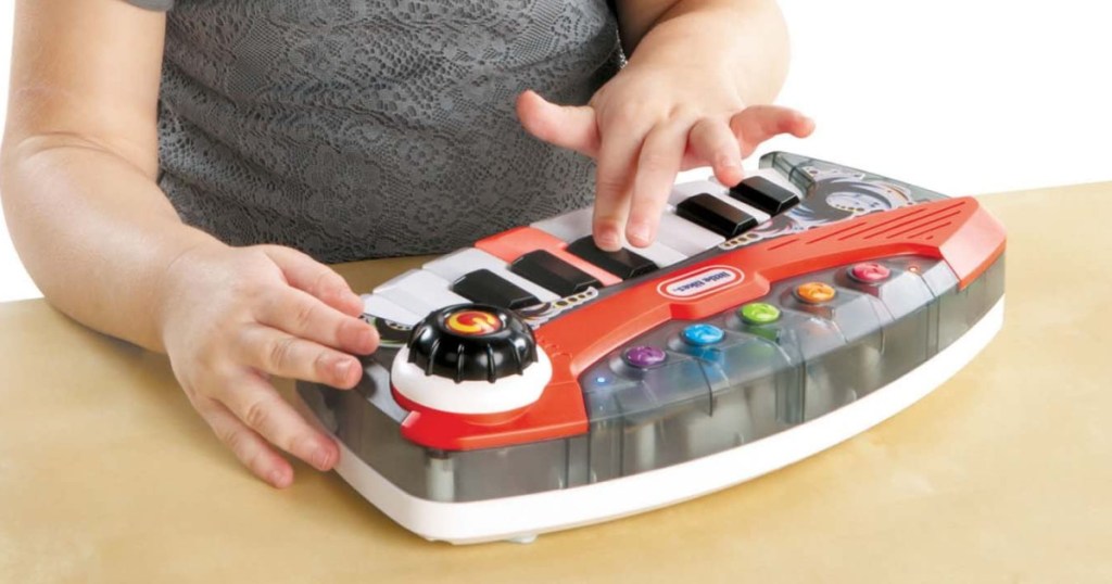 small child tapping on a kids keyboard