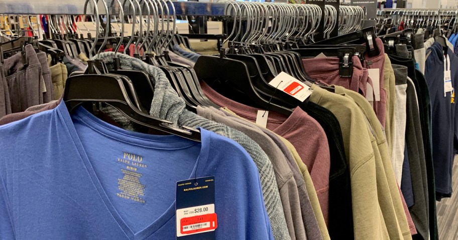 shirts with clearance price tags hanging on hangers on store display rack