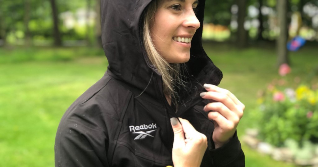 Women wearing a black Reebok coat with the hood pulled up