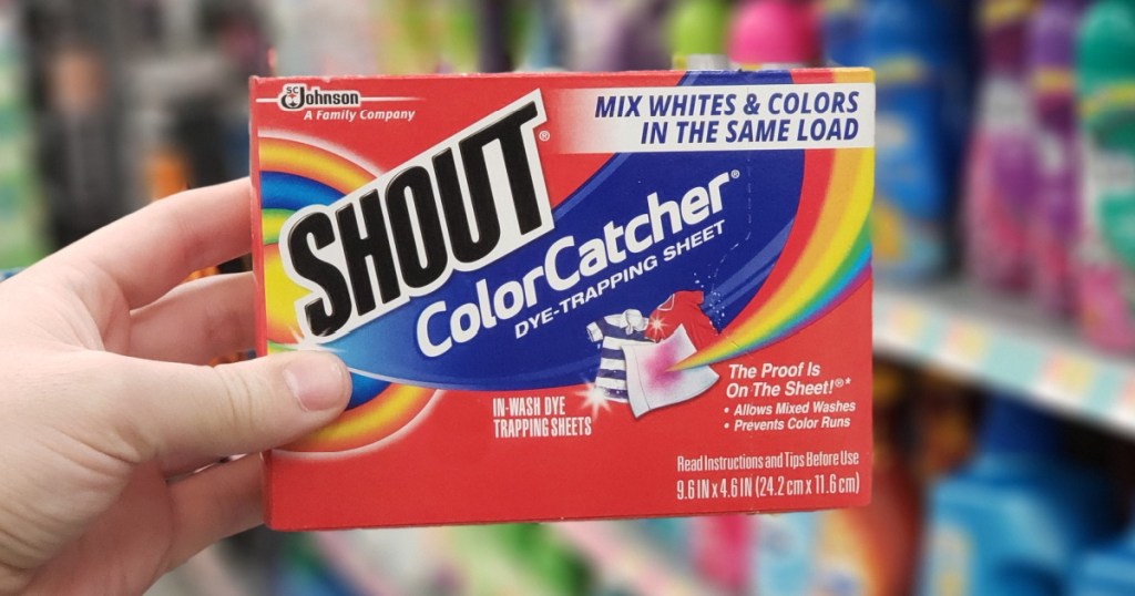 Hand holding Shout Color Catching Sheets in-store