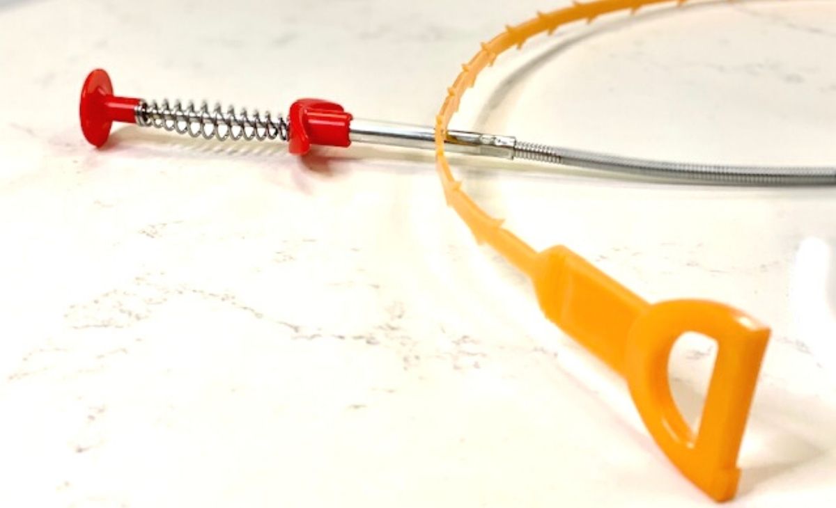 Drain clog remover tools on a counter