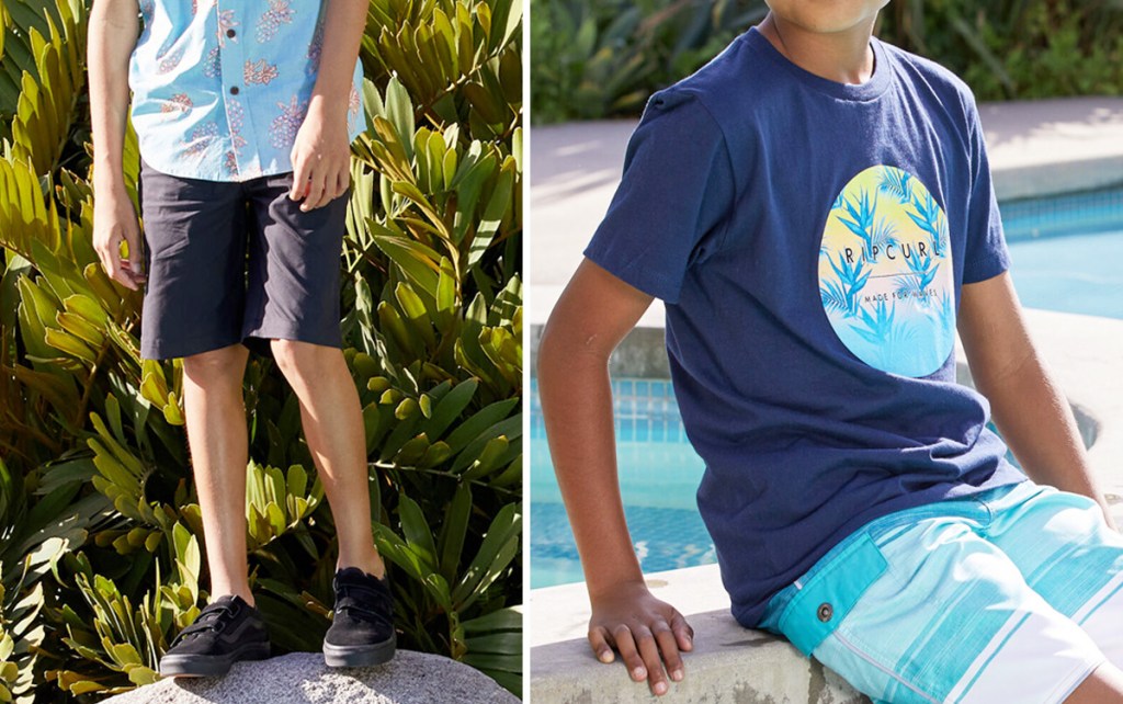 boy standing on rock wearing black shorts and blue tee and boy sitting by pool wearing blue billabong graphic tee and blue swim trunks