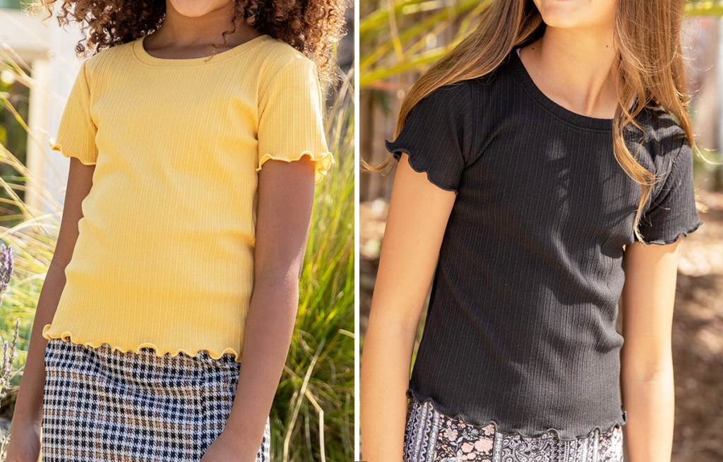 two girls wearing solid colored yellow and black tees with ruffle hems