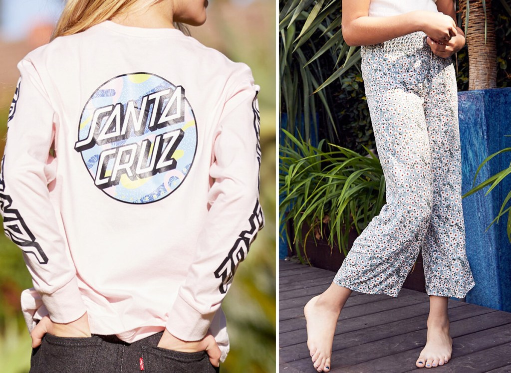 girl standing with hands in her back pockets wearing black jeans with light pink Santa Cruz long sleeve graphic tee and girl standing outside wearing white tee and floral print pants