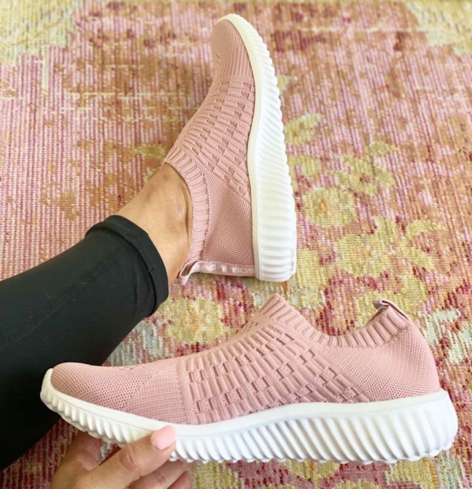 hand holding a pink shoe