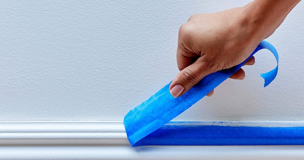 scotch blue painters tape being removed from wall