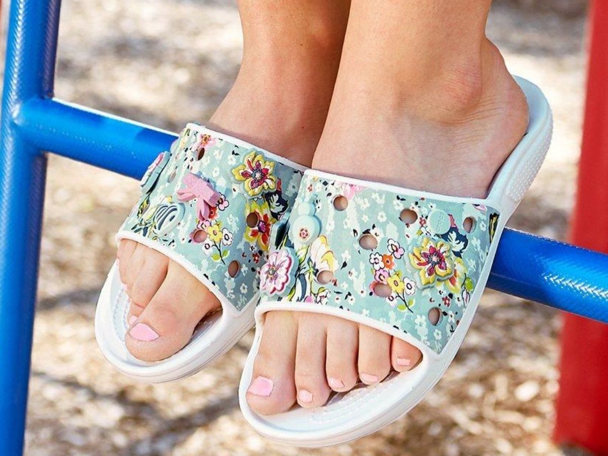 woman wearing garden slides in a floral pattern