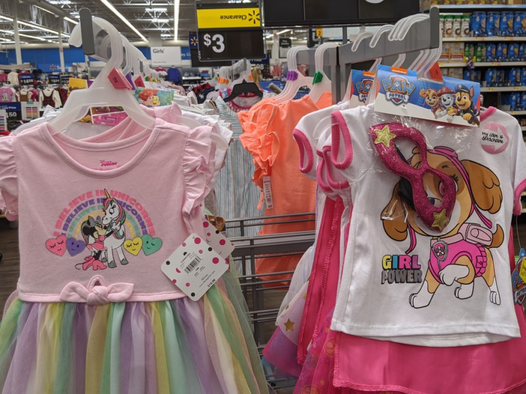 bright colored girls dresses hanging on a rack in store
